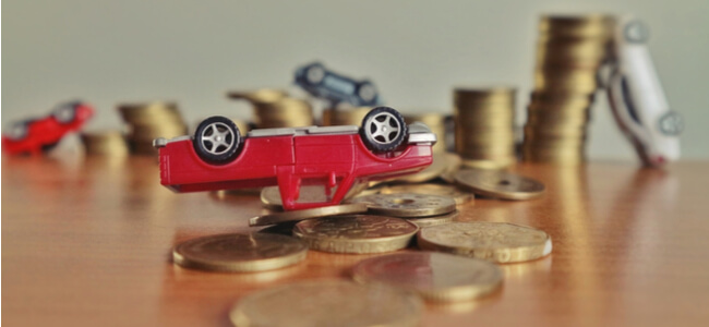 Upside down red car on coins